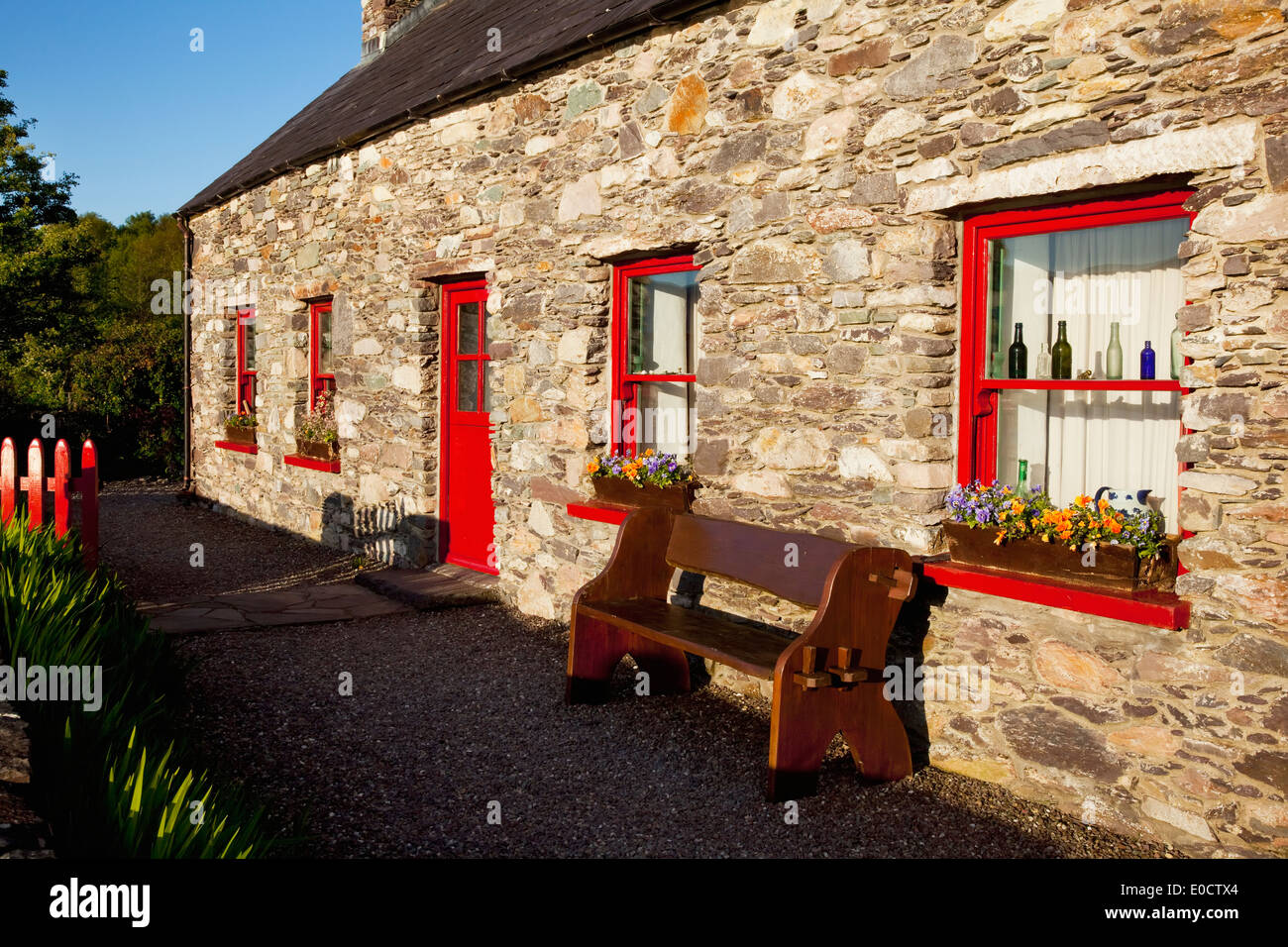 A Stone Cottage With Red Door And Red Window Trim Sneem County