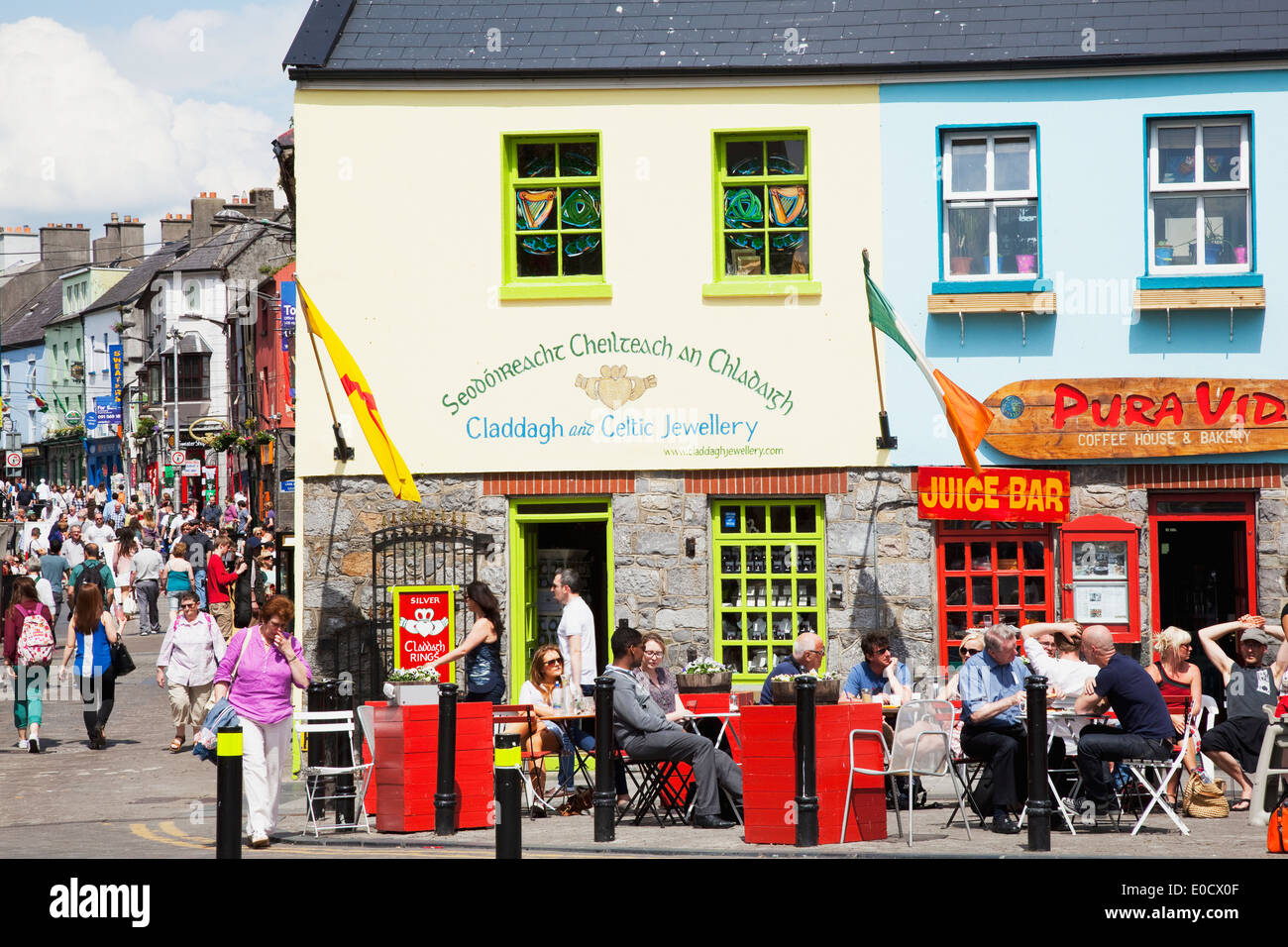 Busy streets with pedestrians and patrons on a cafe patio; Galway City