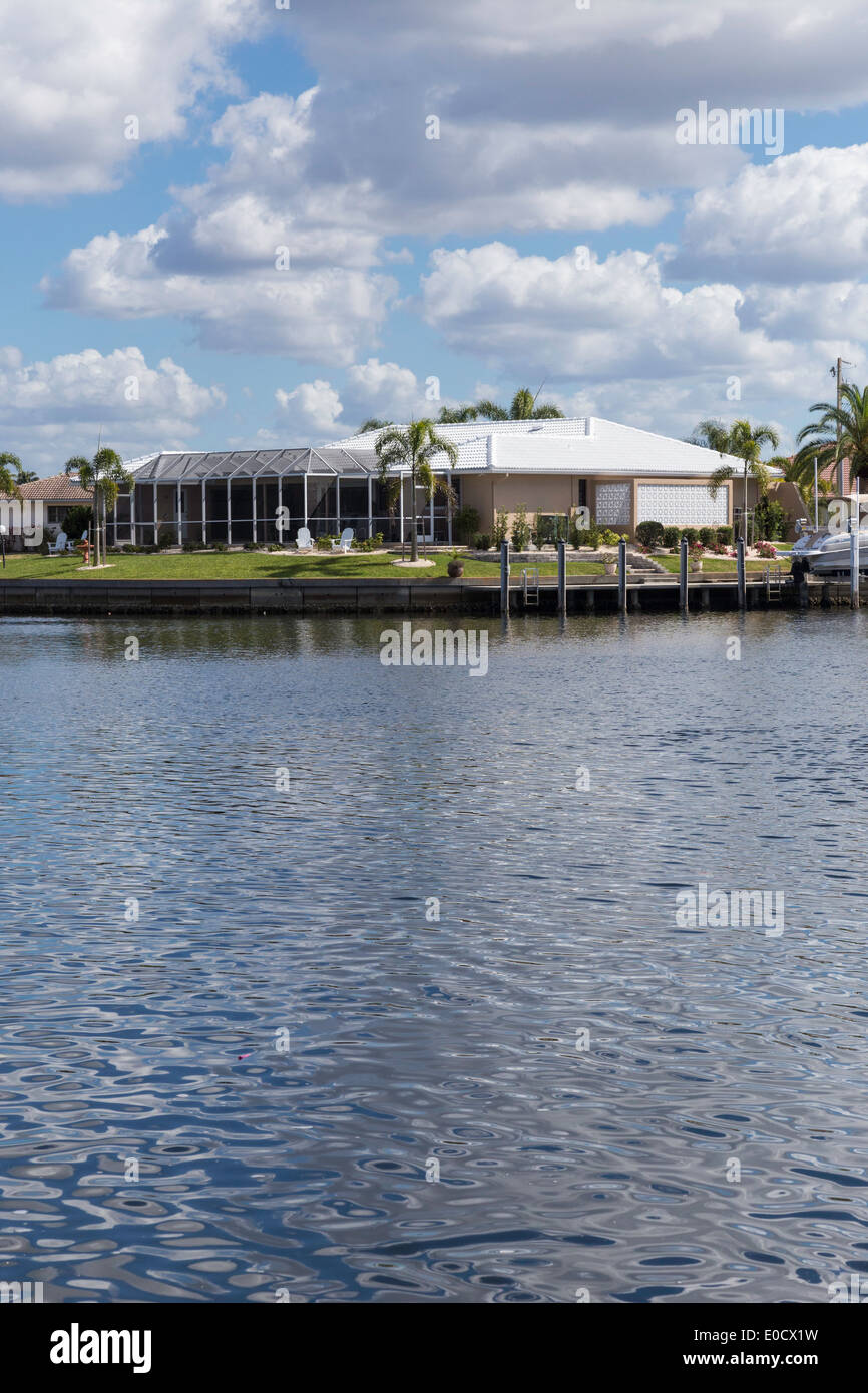 Luxury Residential Canal Front Home with Screened in Pool Deck and