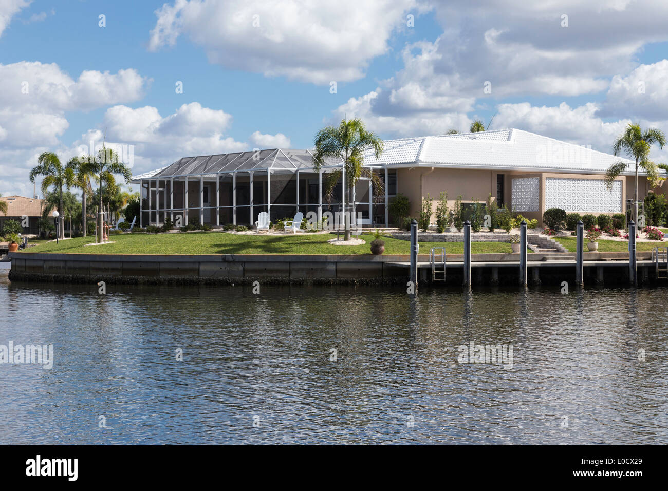 Luxury Residential Canal Front Home with Screened in Pool Deck and