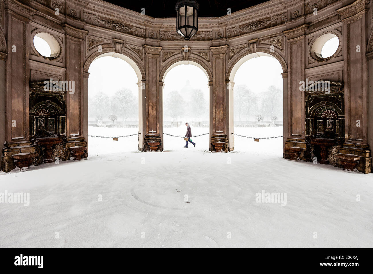 Man walking near Hofgartenpavillion in snow, Hofgarten, Munich, Upper Bavaria, Bavaria, Germany Stock Photo