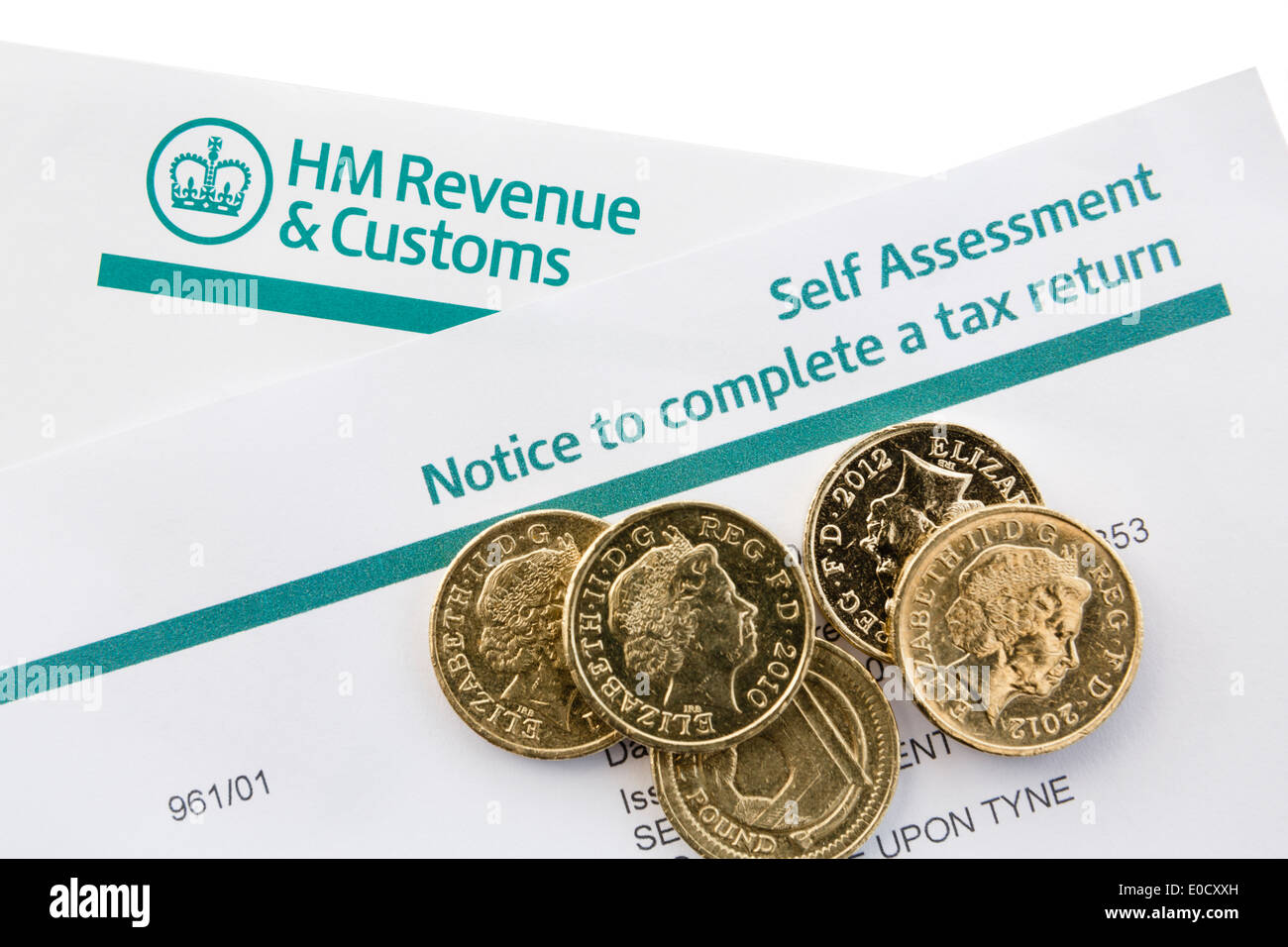 UK HM Revenue & Customs Self Assessment Notice to complete a tax return with some pound coins on white. England Britain Stock Photo
