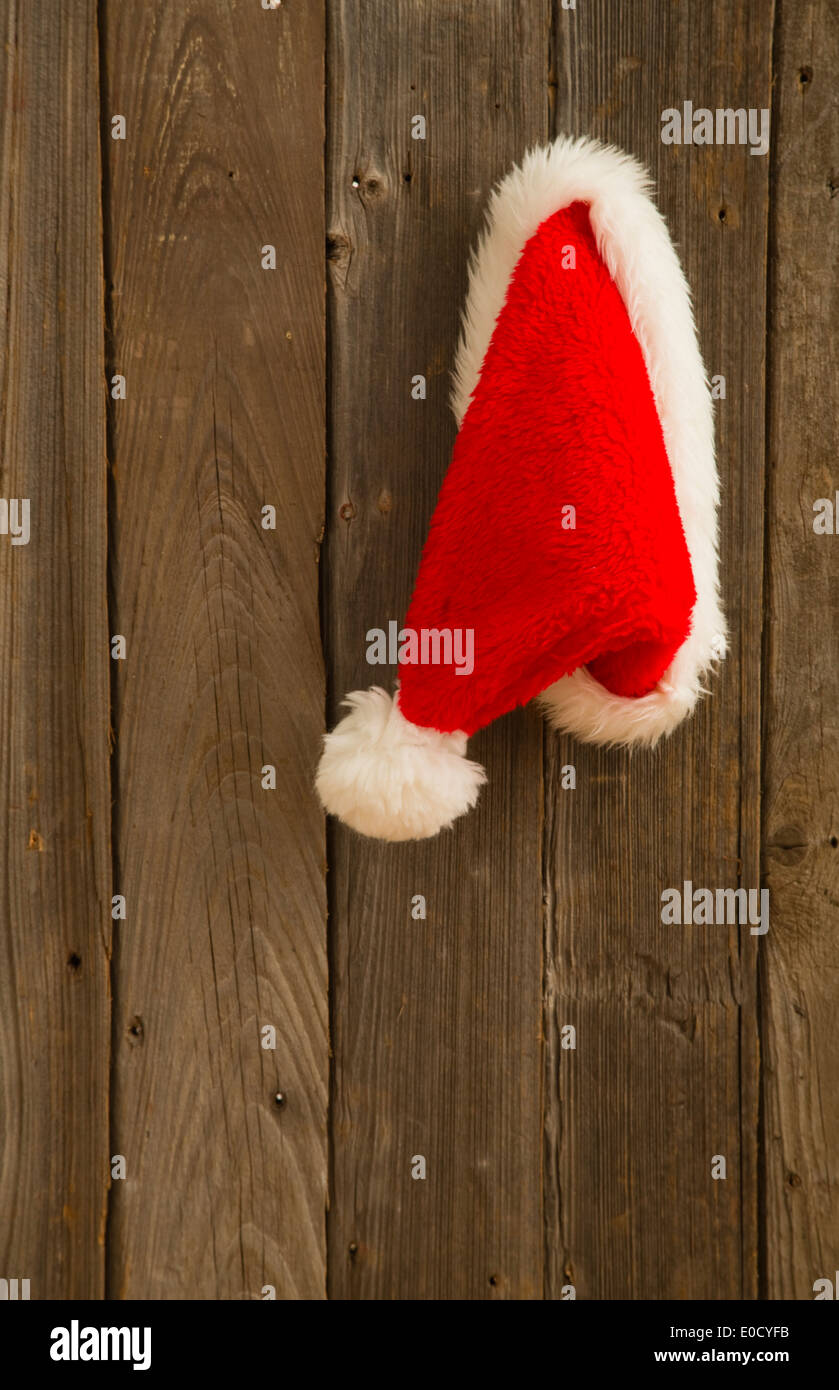 Santa hat hanging on wooden door Stock Photo