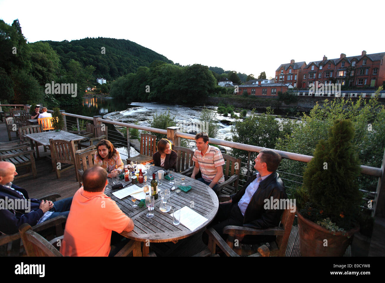 People on the terrace of the Corn Mill restaurant at the Dee river in Langollen, North Wales, Great Britain, Europe Stock Photo