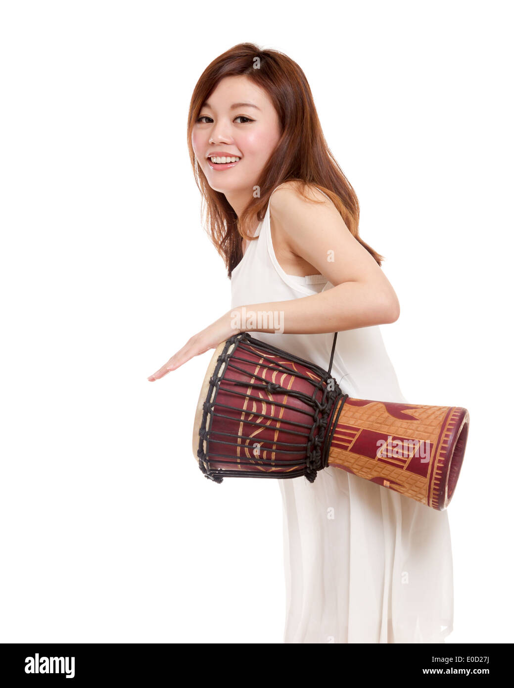 Asian woman playing an african hand drum Stock Photo - Alamy