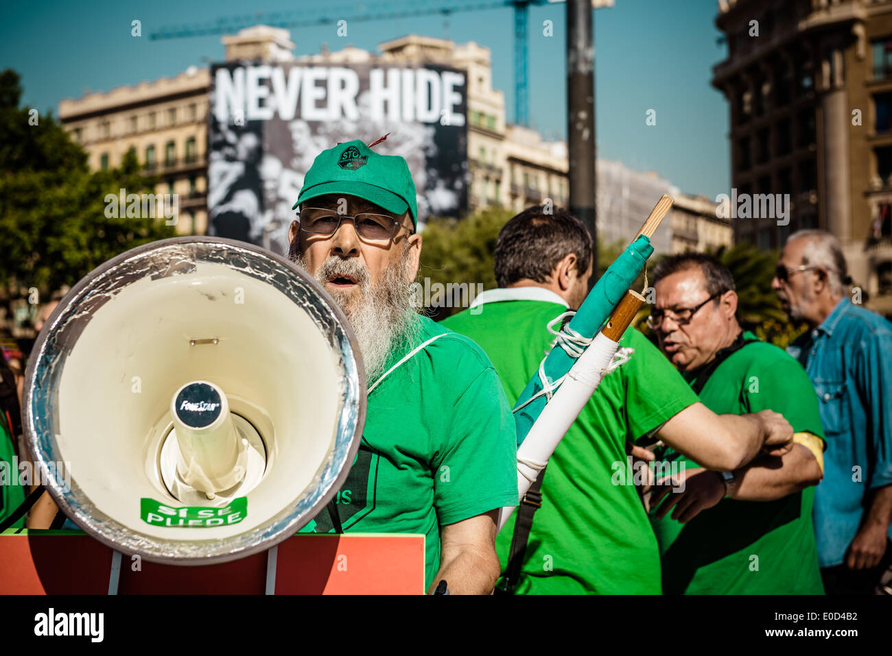 Barcelona, Spain. May 9th, 2014: An activist of the anti-eviction group 'PAH', the Platform of People Affected by Mortgages, with his megaphone during the 'TicTac' protest in Barcelona Credit:  matthi/Alamy Live News Stock Photo