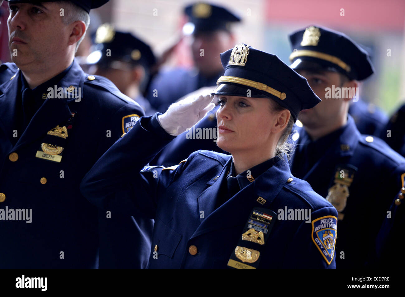 New York, USA. 9th May, 2014. Police officers salute at a memorial ceremony to honor 13 fallen members of the New York City Police Department during 2013, at One Police Plaza in New York, the United States, May 9, 2014. Credit:  Wang Lei/Xinhua/Alamy Live News Stock Photo