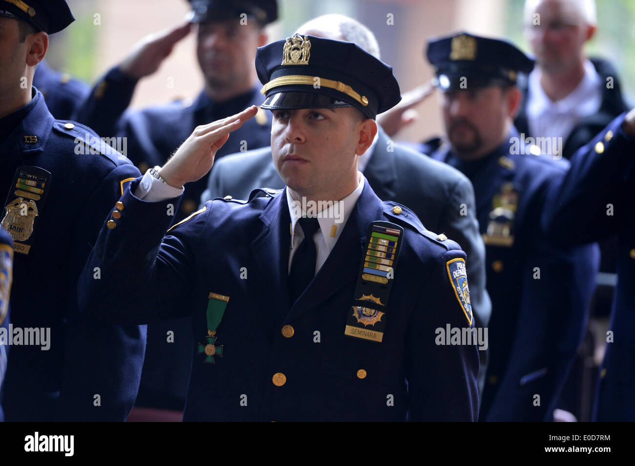 New York, USA. 9th May, 2014. Police officers salute at a memorial ceremony to honor 13 fallen members of the New York City Police Department during 2013, at One Police Plaza in New York, the United States, May 9, 2014. Credit:  Wang Lei/Xinhua/Alamy Live News Stock Photo