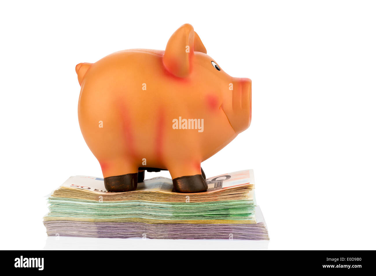 A piggy bank stands on bank notes, symbolic photo for thrift, profitability, yield, Ein Sparschwein steht auf Banknoten, Symbolf Stock Photo