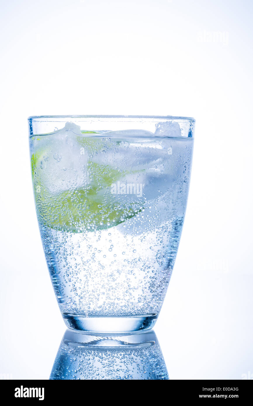 A glass with fresh drinking water and a lime. Mineral water as a Durstloescher., Ein Glas mit frischem Trinkwasser und einer Lim Stock Photo