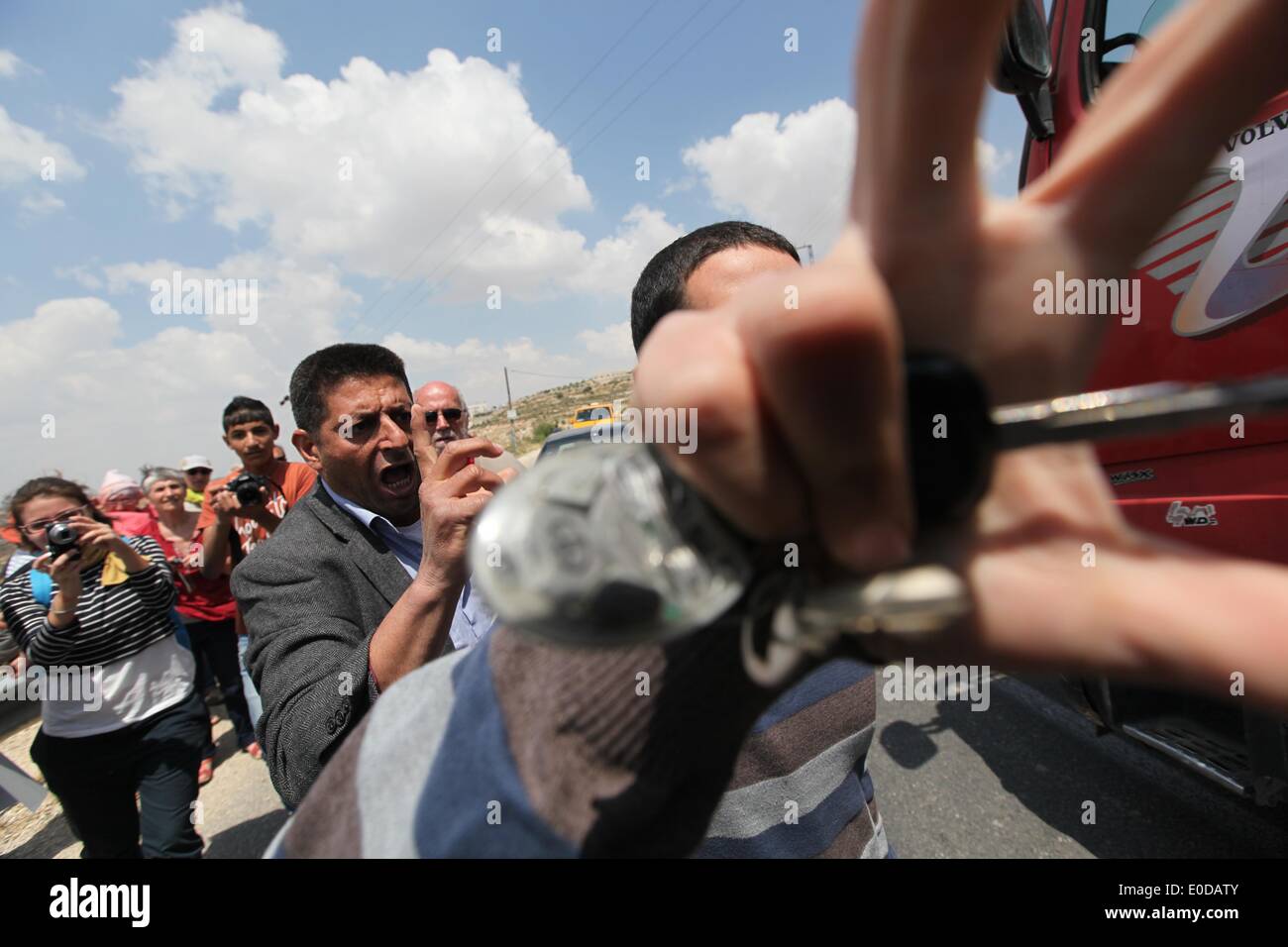 (140509) -- Bethlehem, May 9, 2014 (Xinhua) -- An Israeli Jewish settler attempts to block a photographer's camera as he tries to interrupt Palestinians and foreign peace activists attending a protest against Israel's controversial separation barrier in Al-Maasarah village near the West Bank city of Bethlehem on May 9, 2014. (Xinhua/Luay Sababa) Stock Photo