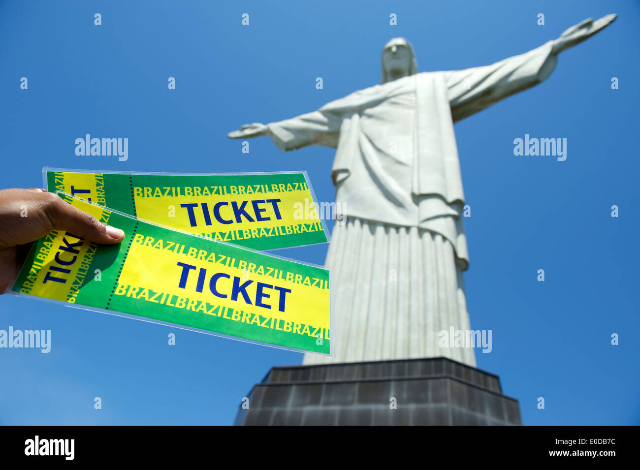 Brazilian hand holding pair of tickets at Corcovado in Rio de Janeiro Brazil Stock Photo