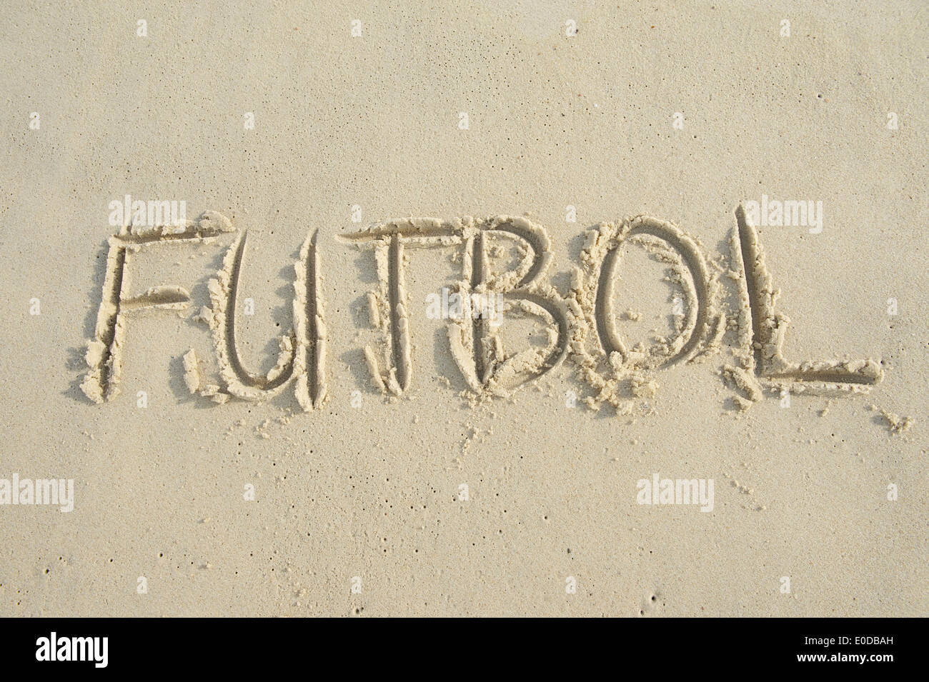 Futbol football handwritten soccer message in capital letter text on bright sunny South American sand beach Stock Photo