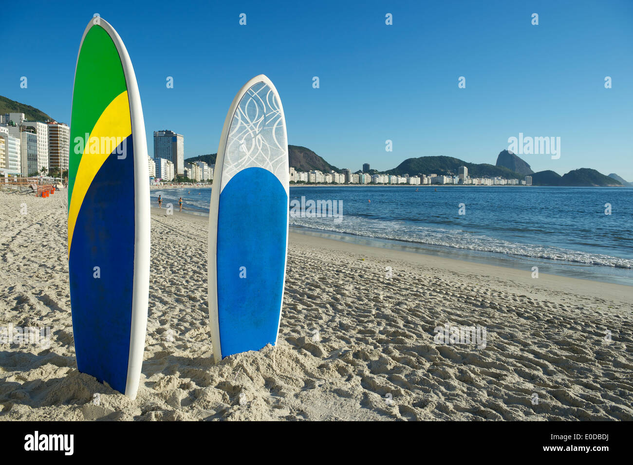 Stand up paddle long board surfboards in Brazil colors on Copacabana Beach Rio de Janeiro Stock Photo