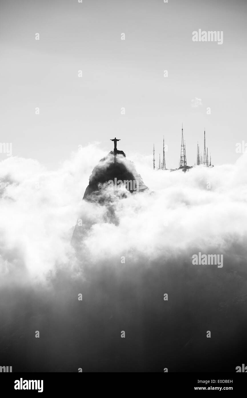 Corcovado mountain Christ the Redeemer standing above glowing swirling mist clouds Rio de Janeiro Brazil Stock Photo
