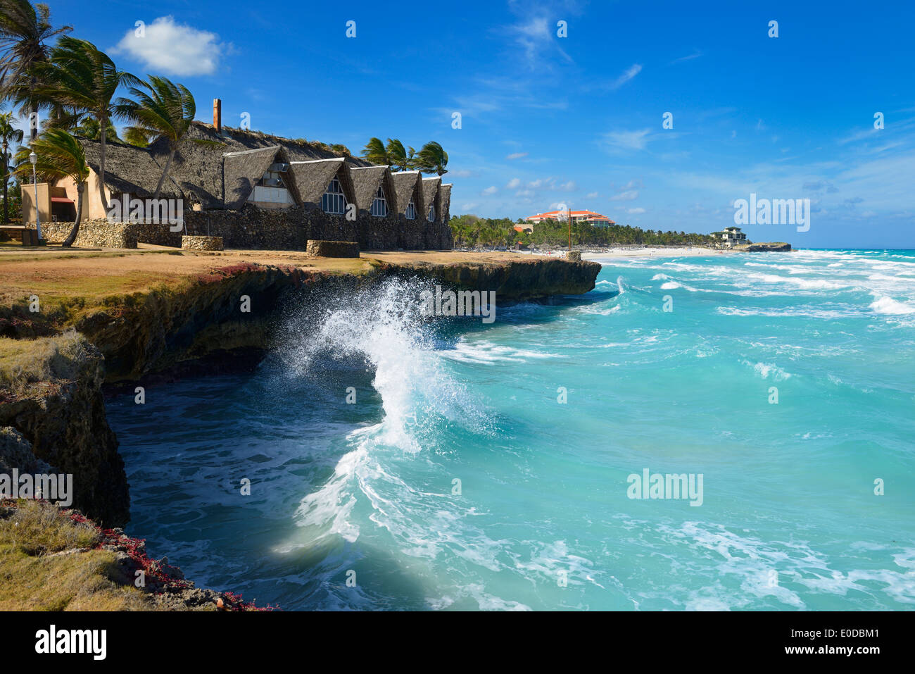 Wave rebounding off lava rock shore causing splash in high wind at Varadero Cuba beach resort Stock Photo