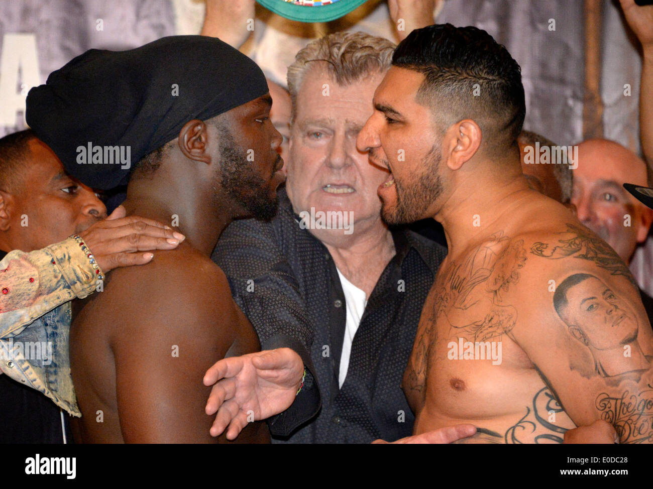 Los Angeles California, USA. 8th May, 2014. Cristobal Arreola(R) who weighed in at 239 pounds has a exchange of words with Bermane Stiverne(L) who weighed in at 238.5 pounds as boxing promoter Dan Goossen(C) tries to keep the two apart at Friday's weigh in at USC. The two will battle it out this Saturday night at USC Galen Center for the WBC HEAVYWEIGHT WORLD CHAMPIONSHIP that will be televise on ESPN. Photos by Gene Blevins/LA DailyNews/ZumaPress Credit:  Gene Blevins/ZUMAPRESS.com/Alamy Live News Stock Photo