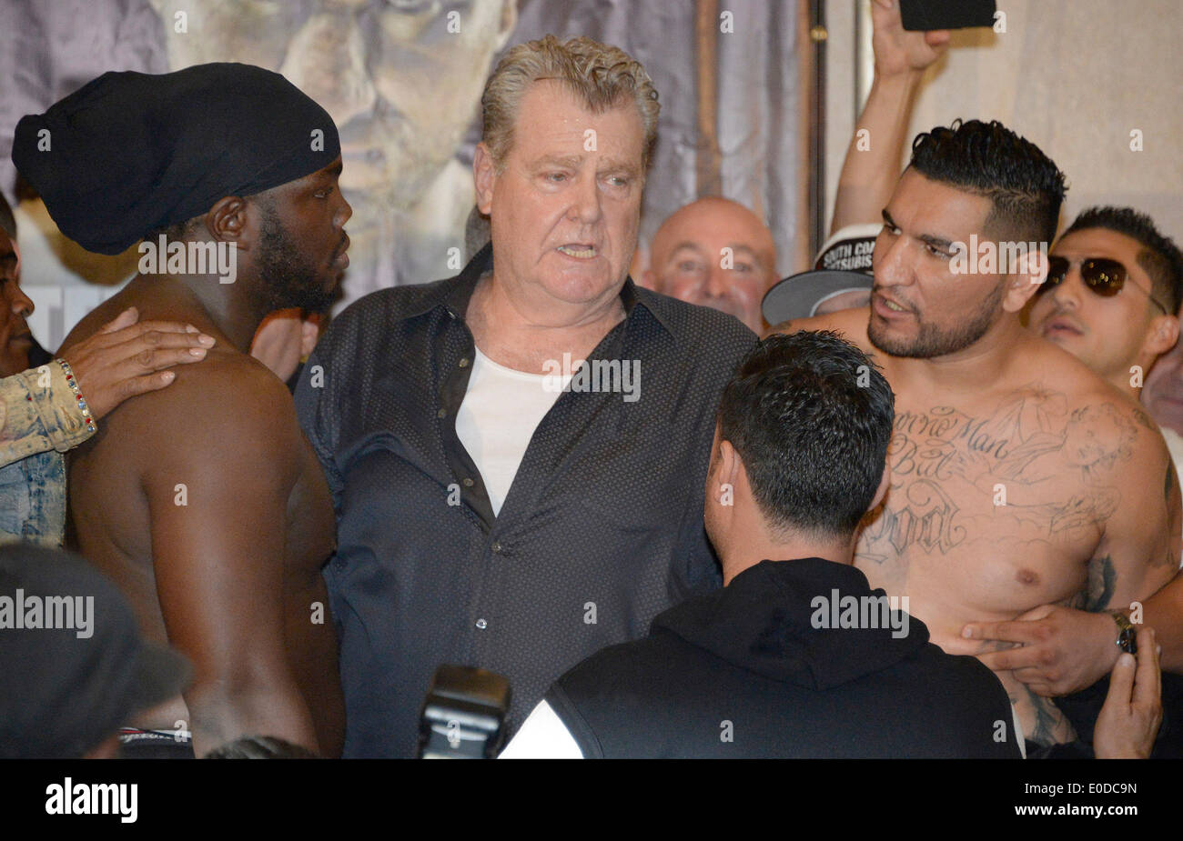 Los Angeles California, USA. 8th May, 2014. Cristobal Arreola(R) who weighed in at 239 pounds has a exchange of words with Bermane Stiverne(L) who weighed in at 238.5 pounds as boxing promoter Dan Goossen(C) tries to keep the two apart at Friday's weigh in at USC. The two will battle it out this Saturday night at USC Galen Center for the WBC HEAVYWEIGHT WORLD CHAMPIONSHIP that will be televise on ESPN. Photos by Gene Blevins/LA DailyNews/ZumaPress Credit:  Gene Blevins/ZUMAPRESS.com/Alamy Live News Stock Photo