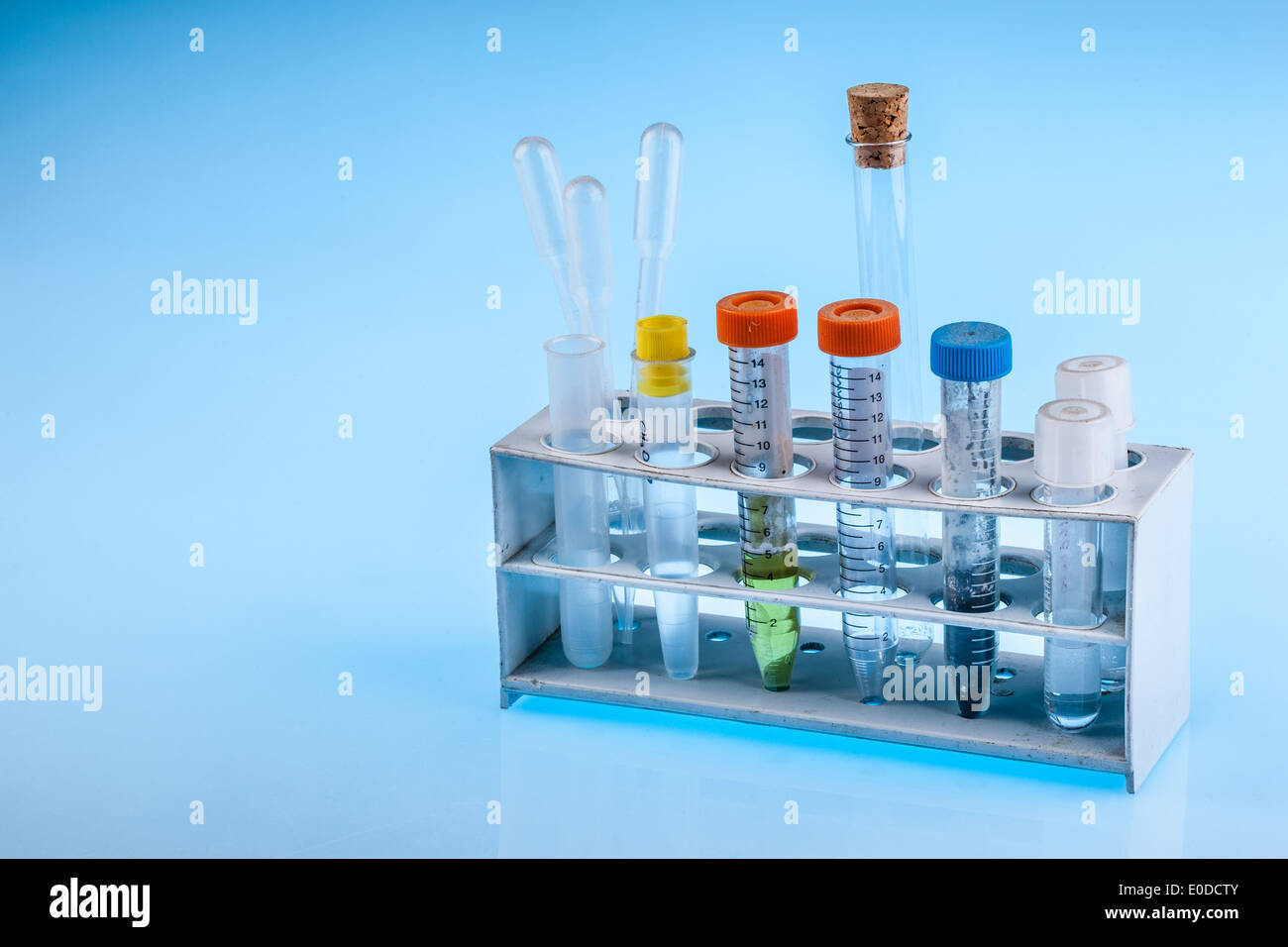 dirty test tobes in a rack over a blue background Stock Photo - Alamy
