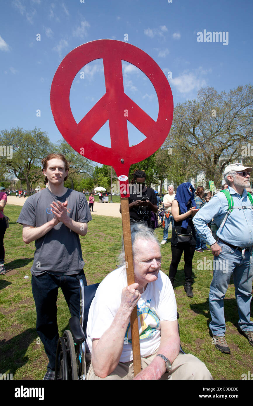 Elderly man holding peace sign picket at rally Stock Photo