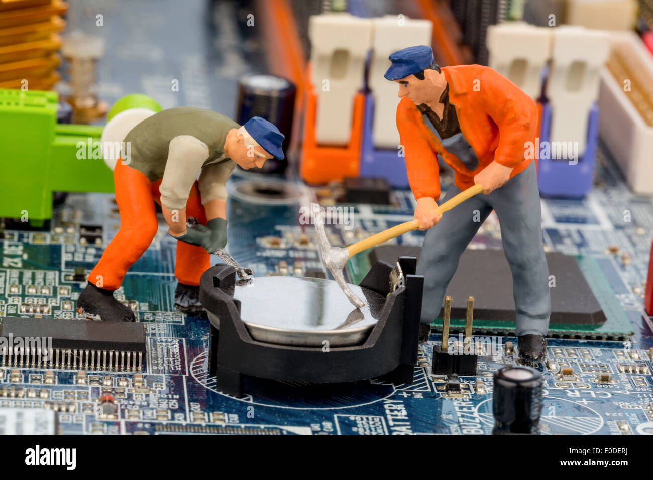 A worker repairs the board of a computer. Symbolic photo for data security, Ein Arbeiter repariert die Platine eines Computers. Stock Photo