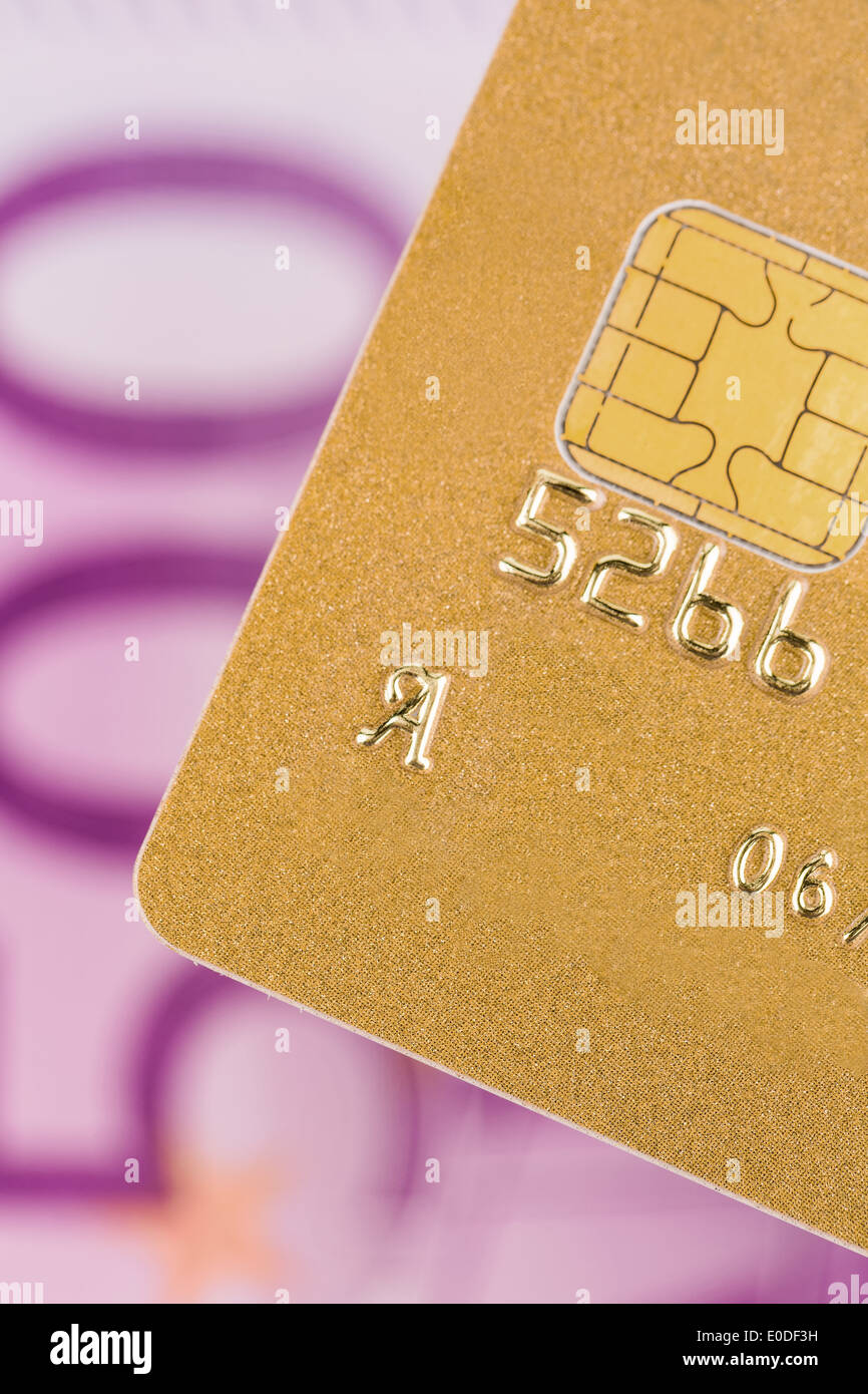 A golden credit card to the cashless payment with an eurolight, Eine Goldene Kreditkarte zum Bargeldlosen Bezahlen mit einem Eur Stock Photo