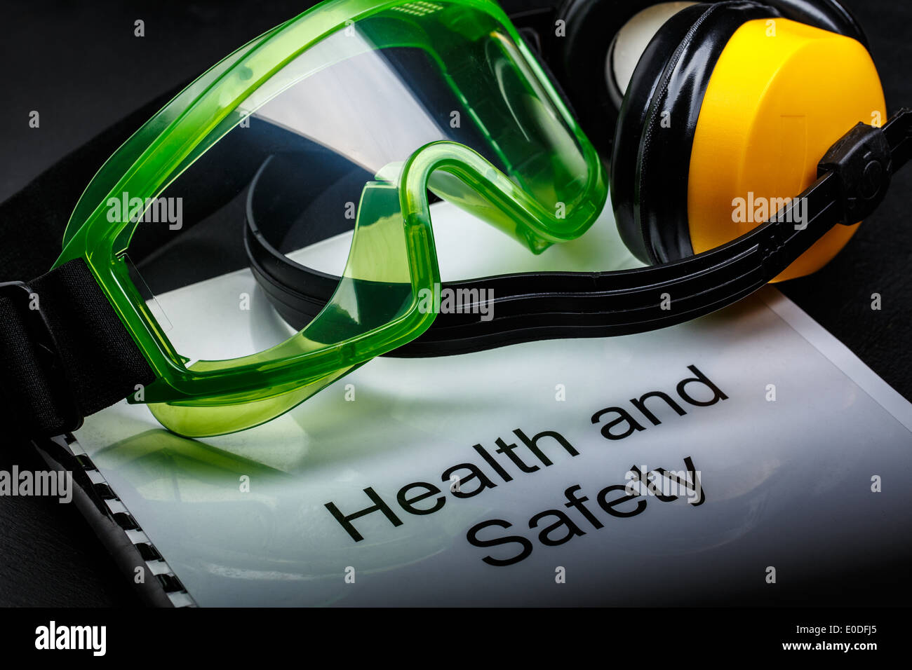 Health and safety register with goggles and earphones Stock Photo