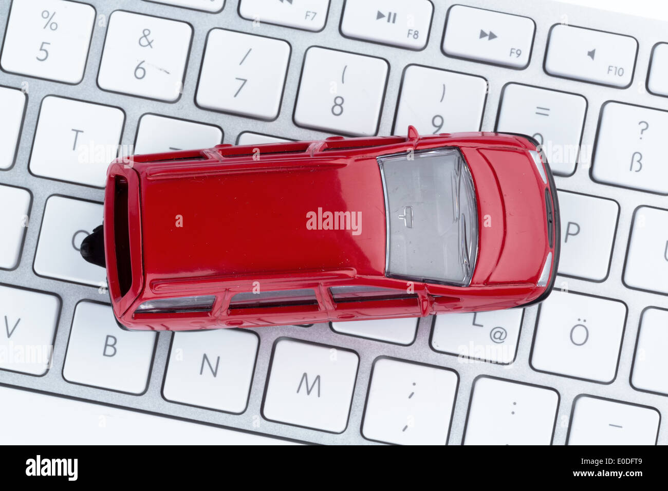 Car on keyboard, symbolic photo for autopurchase and automobile business on the Internet, Auto auf Tastatur, Symbolfoto fuer Aut Stock Photo