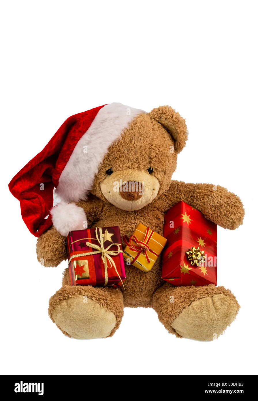 A teddy bear with presents at Christmas. When Santa Claus dresses up., Ein Teddybaer mit Geschenken zu Weihnachten. Als Weihnach Stock Photo