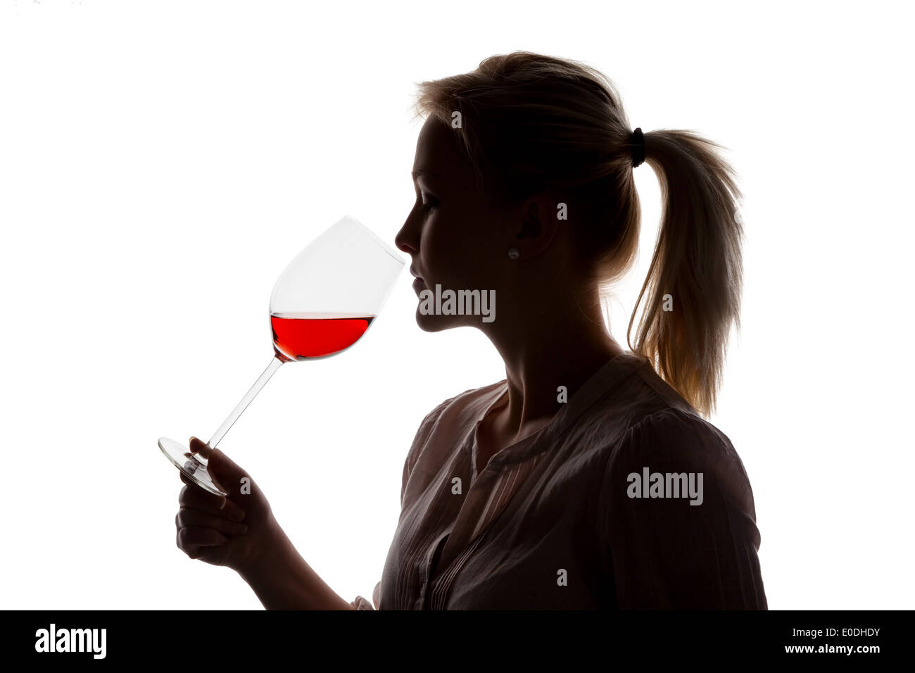 A young woman with a Weinverkostung. If a glass of red wine tries in the red wineglass, Eine junge Frau bei einer Weinverkostung Stock Photo