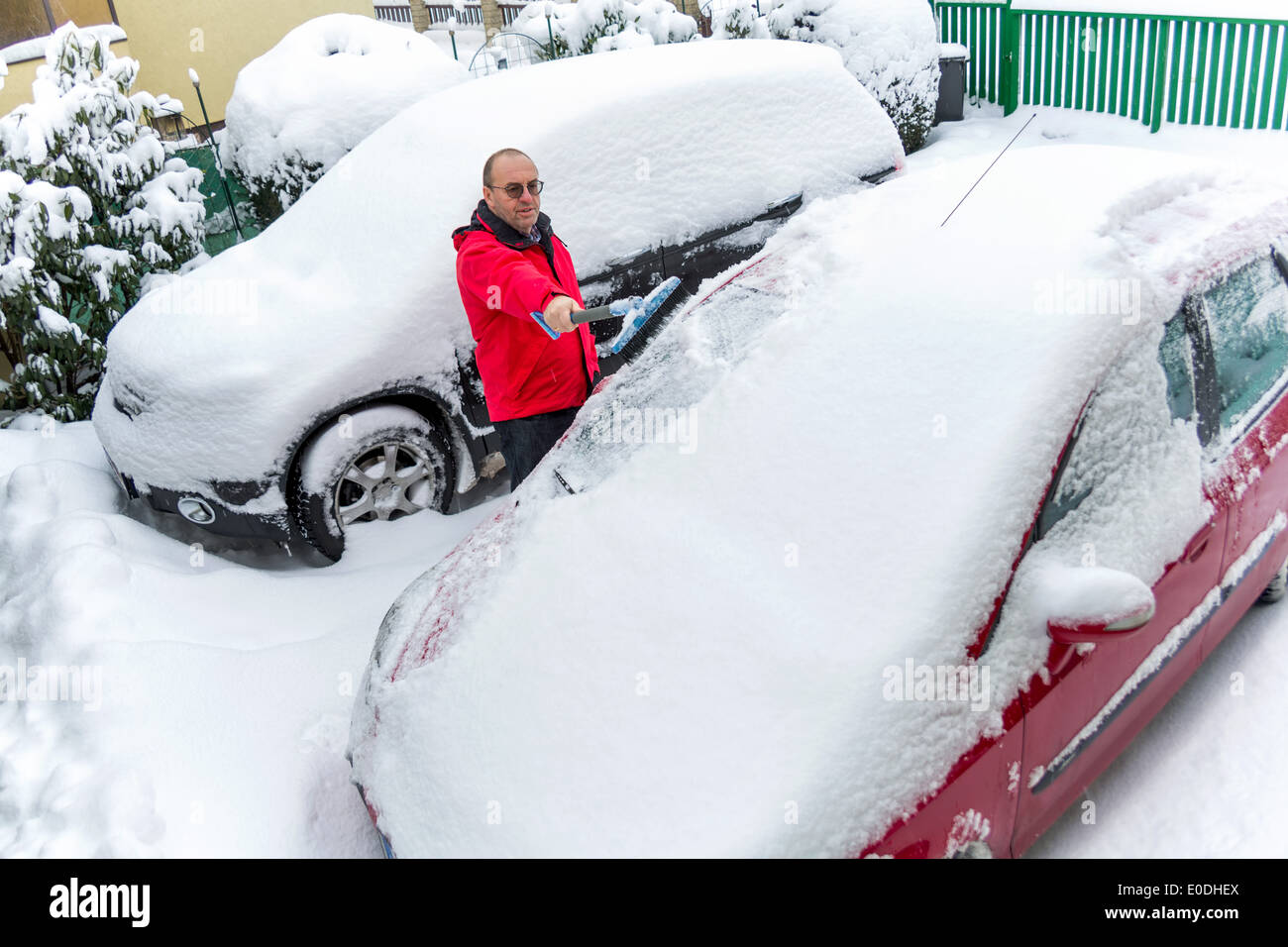 Snow is shoveled by a car away. Snowy clearing in winter, Schnee wird von einem Auto weg geschaufelt. Schneeraeumung im Winter Stock Photo