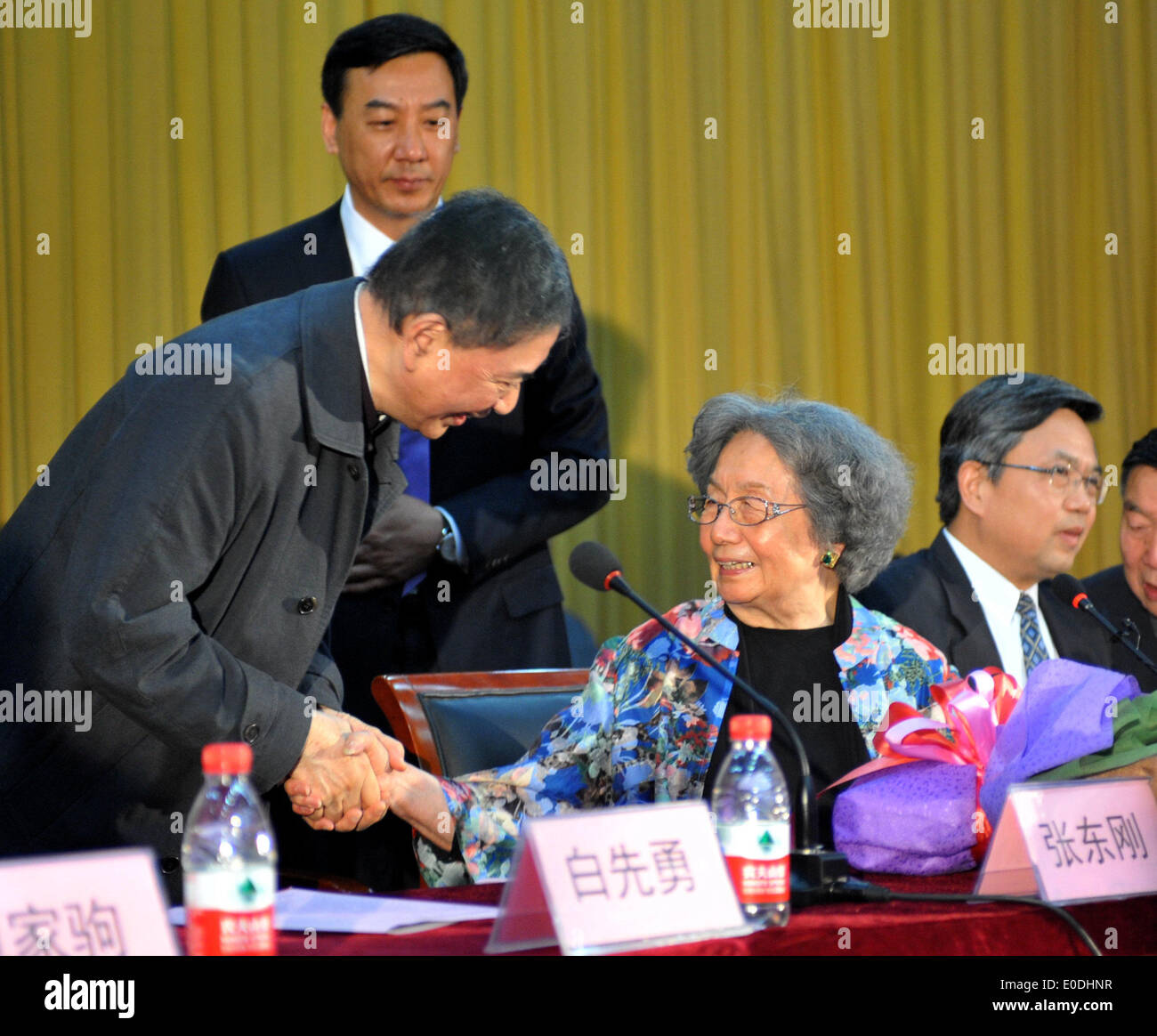 Tianjin, China. 10th May, 2014. Ye Jiaying (R), famous scholar of Chinese literature, shakes hand with writer Pai Hsien-yung during an event to mark Ye's 90th birthday at Nankai University in Tianjin, north China, May 10, 2014. Ye is a professor of classical Chinese literature and also a tenured faculty member at the University of British Columbia in Canada. Credit:  Zhang Chenlin/Xinhua/Alamy Live News Stock Photo