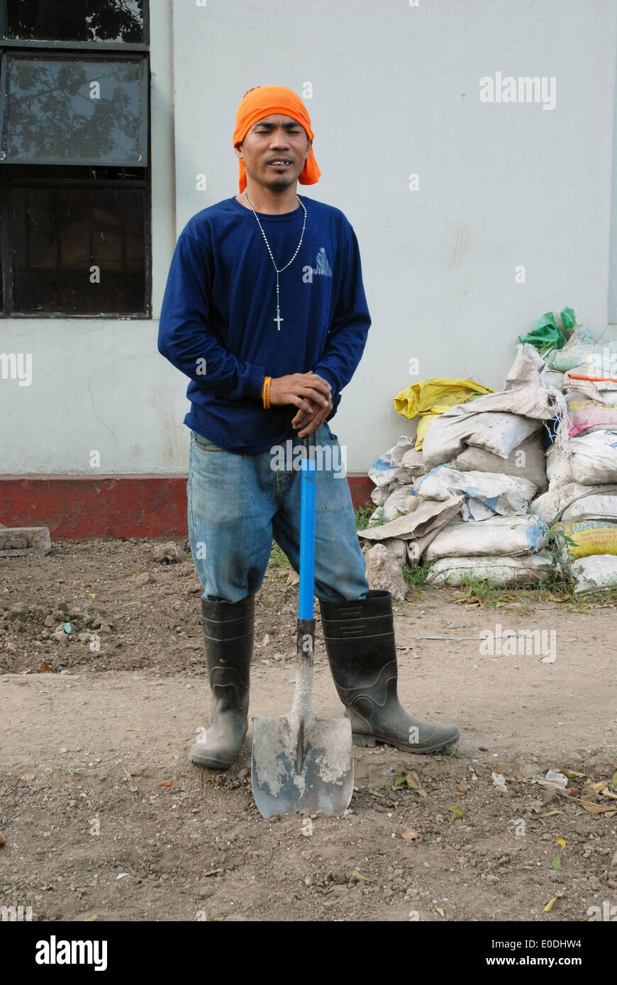 Filipino laborers resting from work at building site, Manila