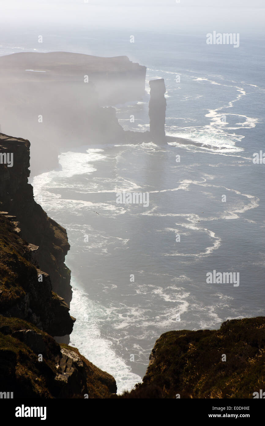 Old Man of Hoy seen through sea mist with the coastal erosion being evident Stock Photo