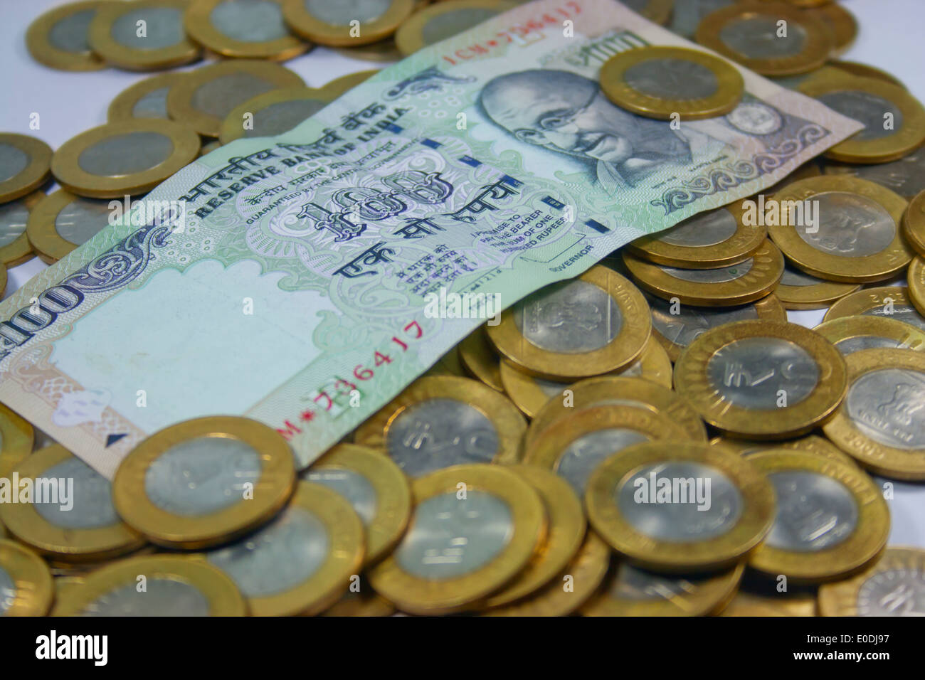 Indian currency notes with stack of coins Stock Photo