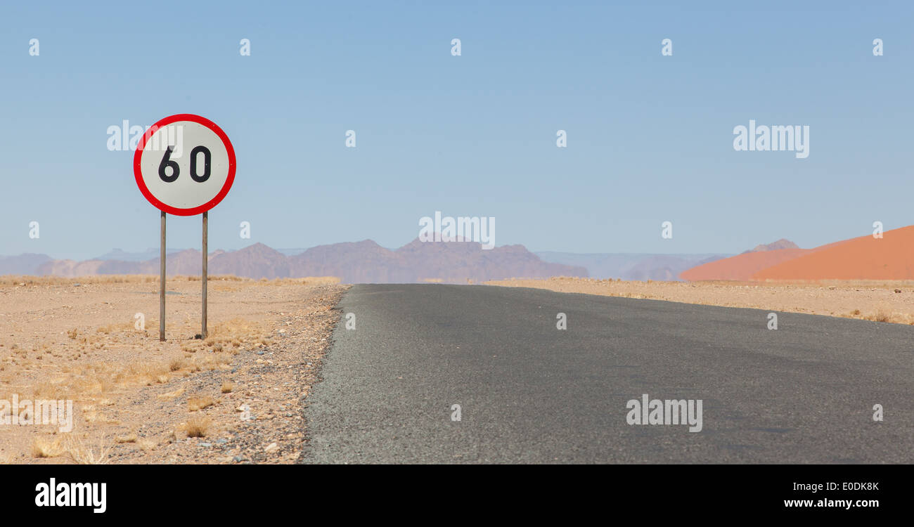 Speed limit sign at a desert road in Namibia, speed limit of 60 kph Stock Photo