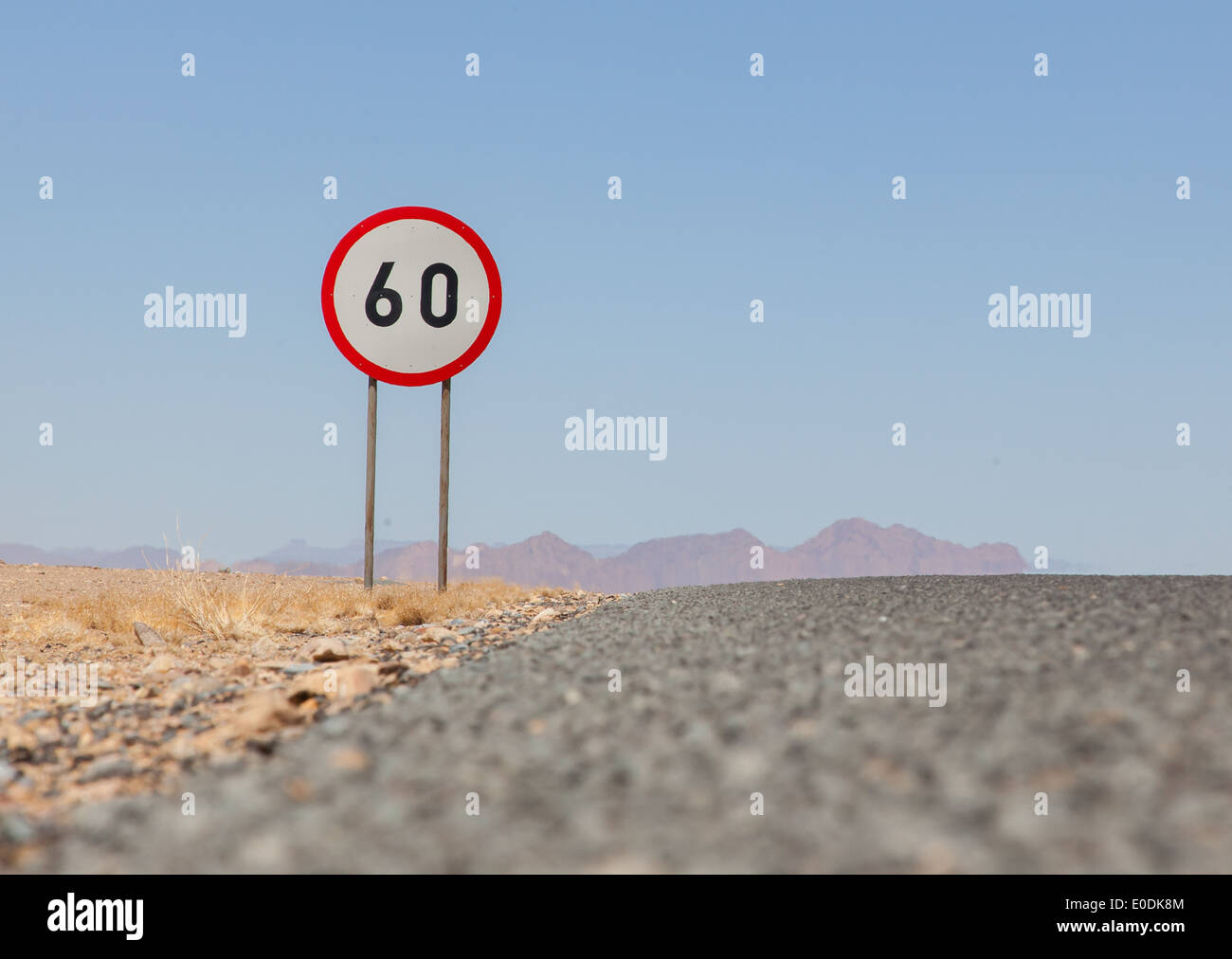 Speed limit sign at a desert road in Namibia, speed limit of 60 kph Stock Photo