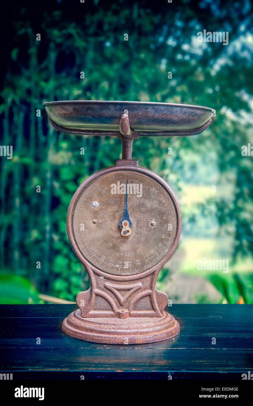 Vintage weight scale machine on old wood table Stock Photo
