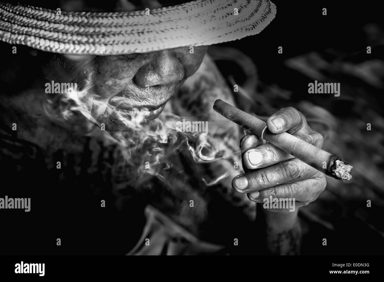 black and white picture of very old Man smoke a cigarette Stock Photo