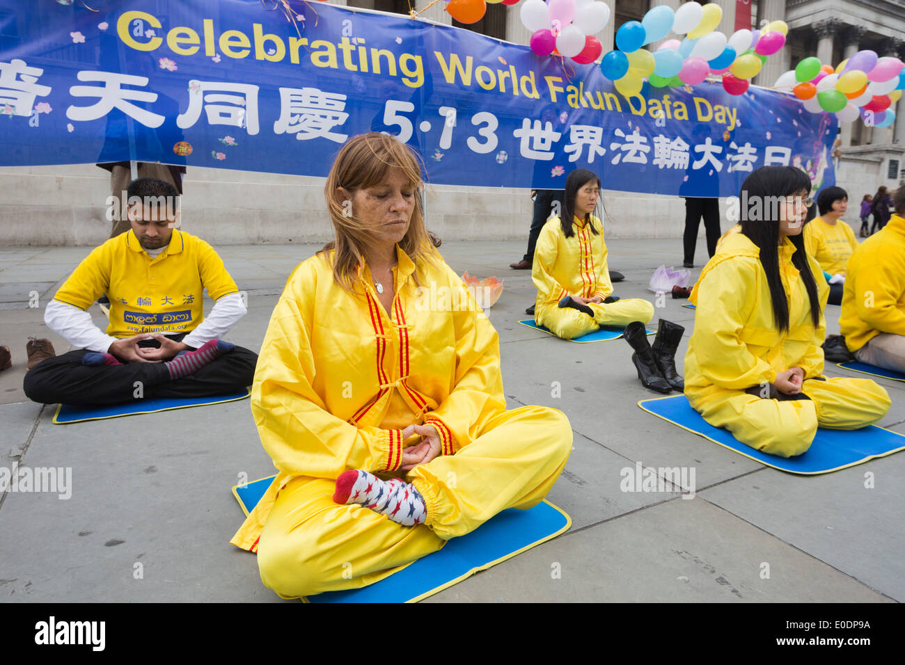 London, UK. 10 May 2014. Falun Dafa/Falun Gong Practitioners celebrate World Falun Dafa Day in London's Trafalgar Square. Falun Dafa is a different name for Falun Gong. Falun Gong is a traditional practive to improve body and mind and it was made public in China in 1992. Due to its popularity it was prohibited in 1999 and its members have since been persecuted and been subject to human rights abuse. The celebration is also a protest to raise awareness. Credit:  Nick Savage/Alamy Live News Stock Photo