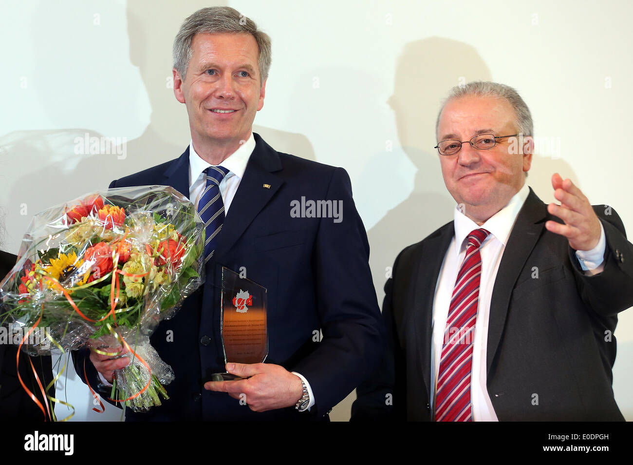 Berlin, Germany. 10th May, 2014. Former German President Christian Wulff stands with chairman of the community Kenan Kolat during the 10th federal congress of the Turkish community in Germany in Berlin, Germany, 10 May 2014. Wulff has been distinguished for his efforts for equality among people of different cultures and religious backgrounds. Photo: WOLFGANG KUMM/dpa/Alamy Live News Stock Photo