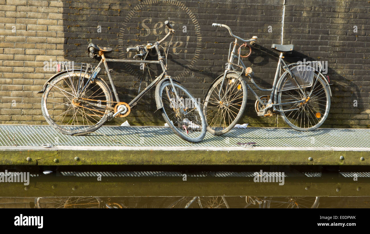 Two rusted bicycles are pulled out of the water Stock Photo