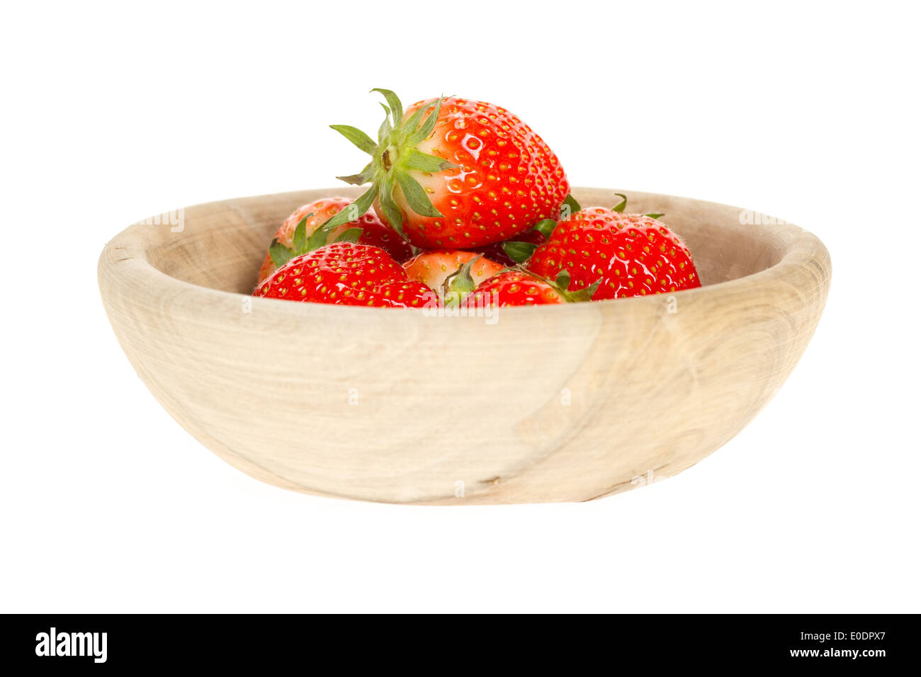 A few strawberries in a wooden bowl Stock Photo - Alamy