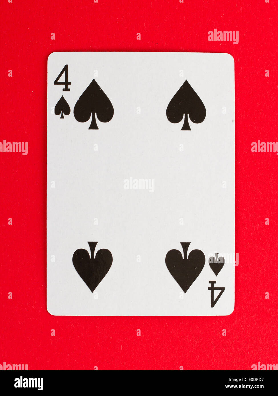 Old playing card (four) isolated on a red background Stock Photo - Alamy