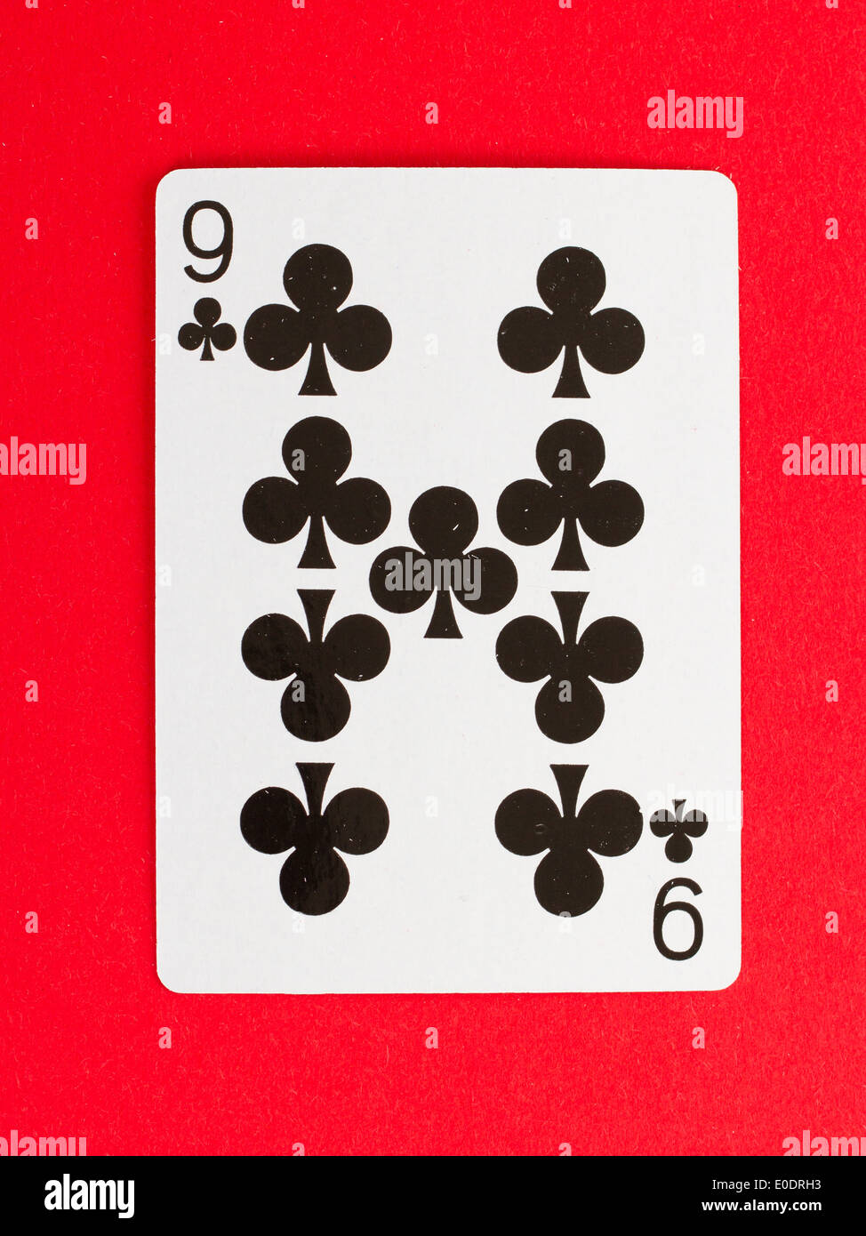 Old playing card (nine) isolated on a red background Stock Photo - Alamy
