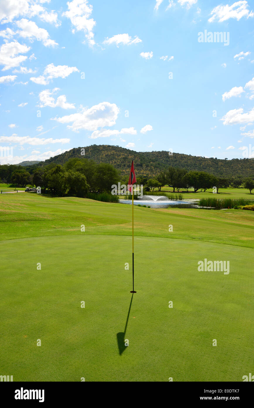 Flag on green, Gary Player Country Club Golf Course, Sun City holiday resort, Pilanesberg, North West Province, Republic of South Africa Stock Photo