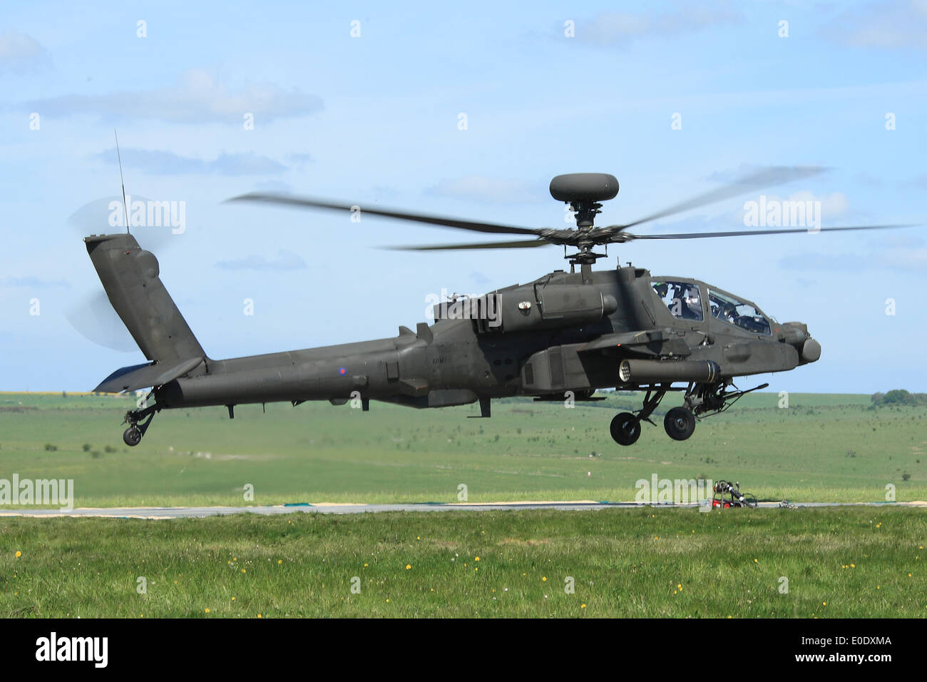 Apache AH1 Longbow helicopter comes in to land in order to refuel in the field during Exercise Patshun Dawn Stock Photo