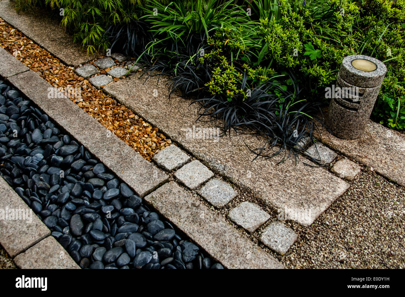 Japanese style gravel garden with Ophiopogon planiscapus nigrescens, Westgate villas, Shropshire Stock Photo