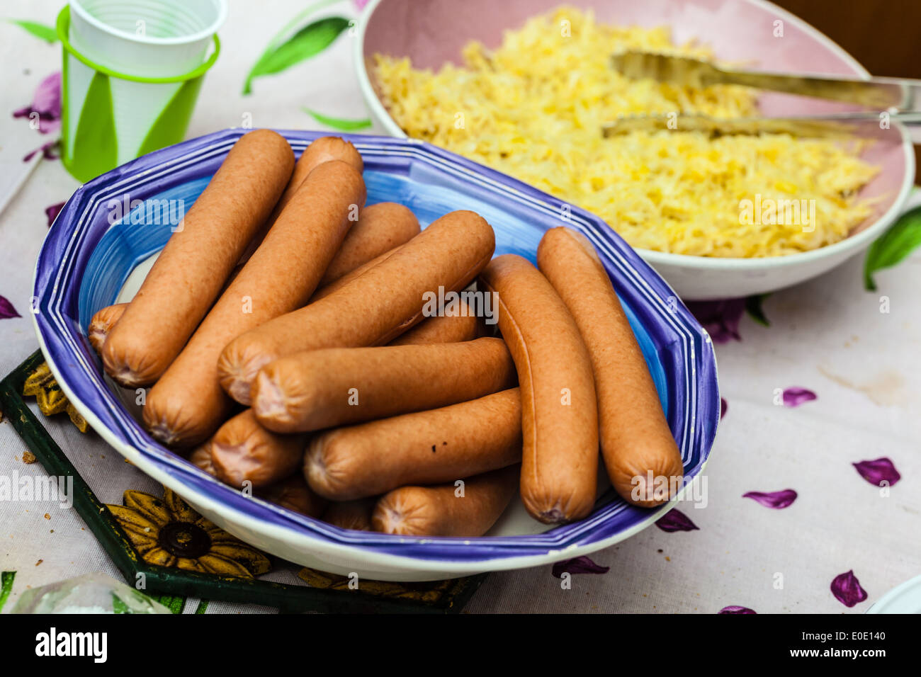 a bowl filled up with a lot of steaming wiener sausages Stock Photo