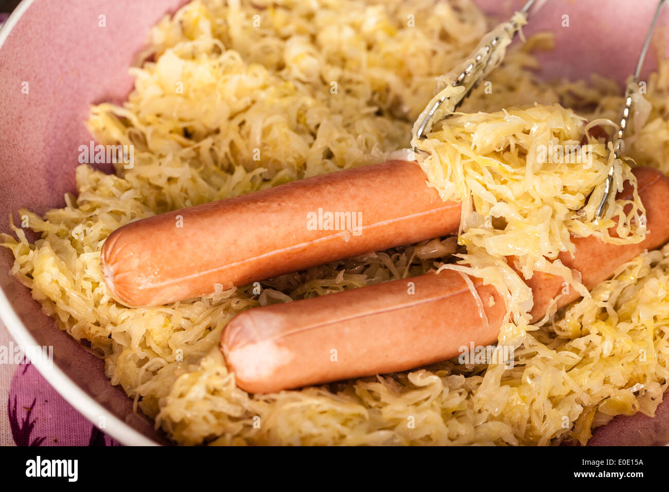 two wiener sausages in a bowl with sauerkraut Stock Photo